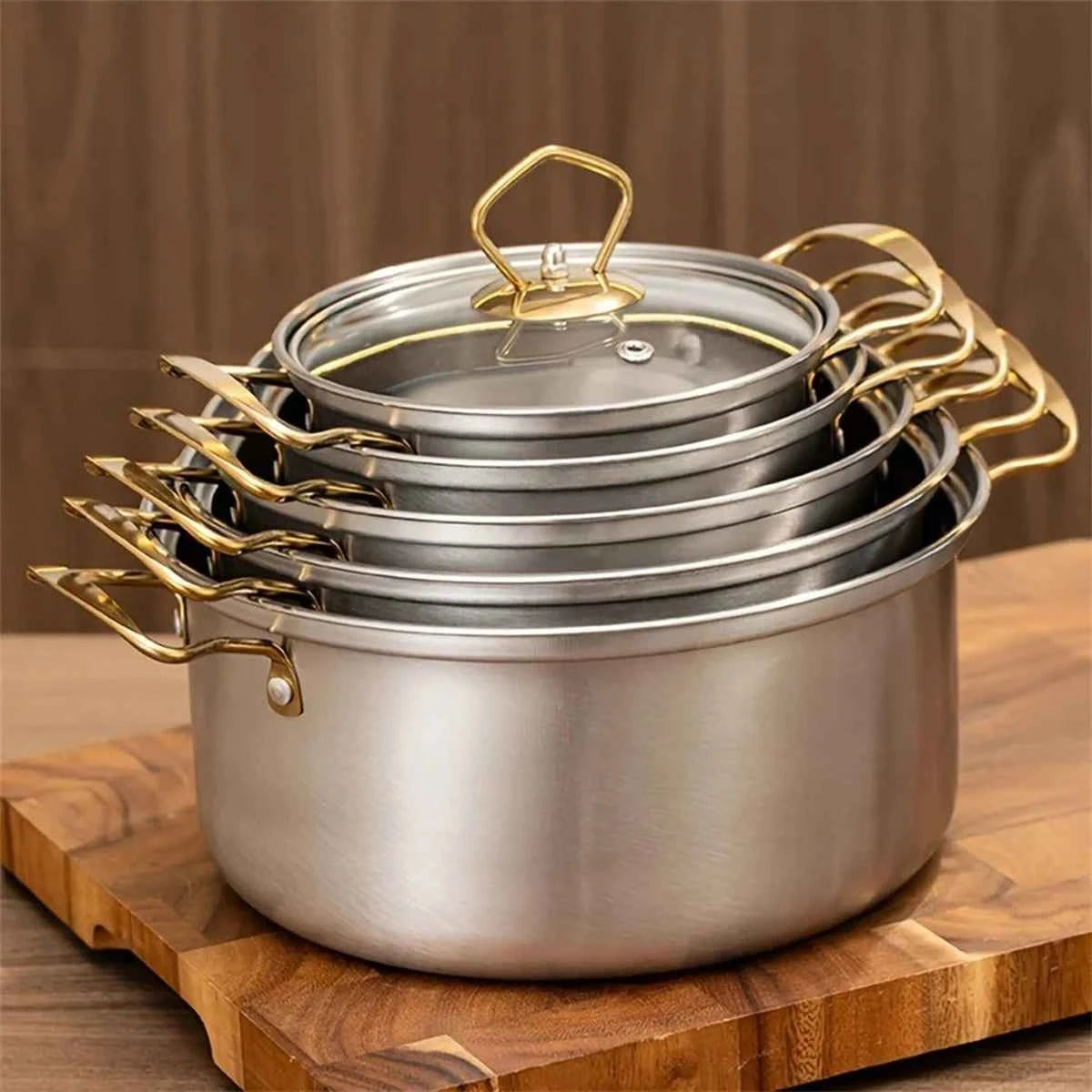 Ensemble complet de 10 pièces de casseroles en acier inoxydable avec poignées dorées et argentées, incluant des couvercles en verre trempé.